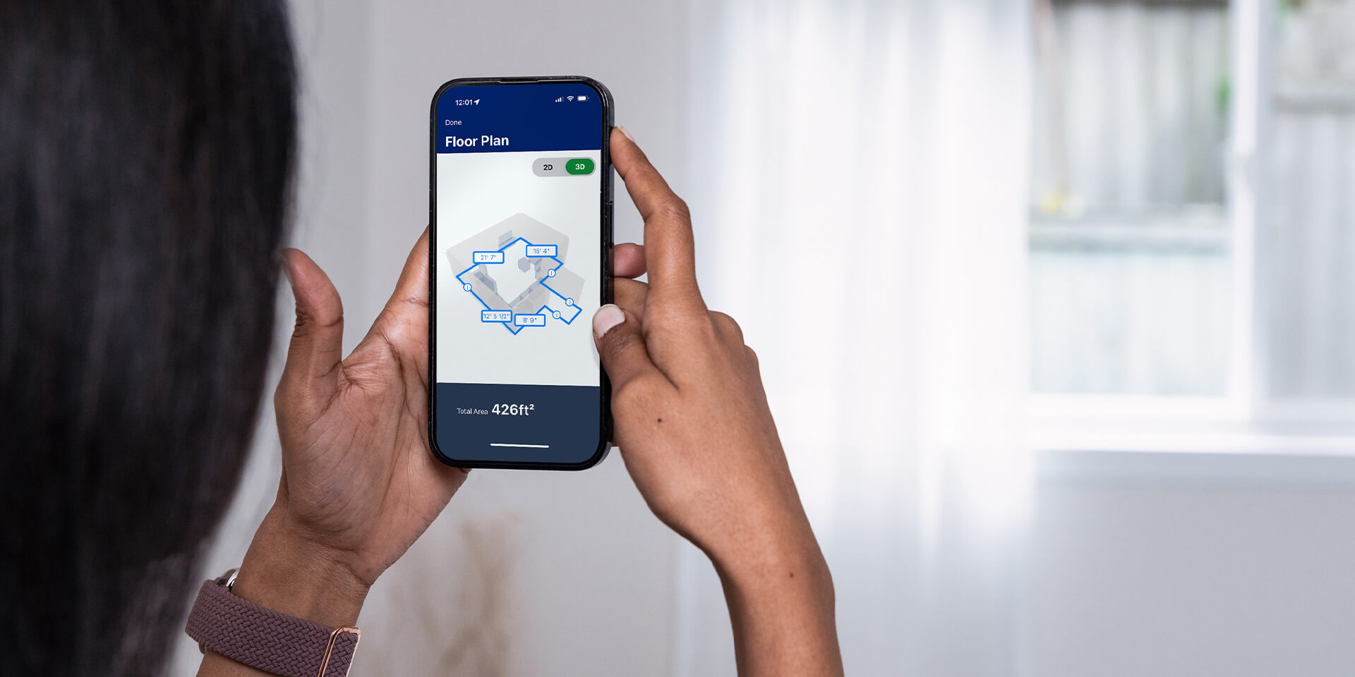 Woman using mobile phone and Lowes App to measure room
