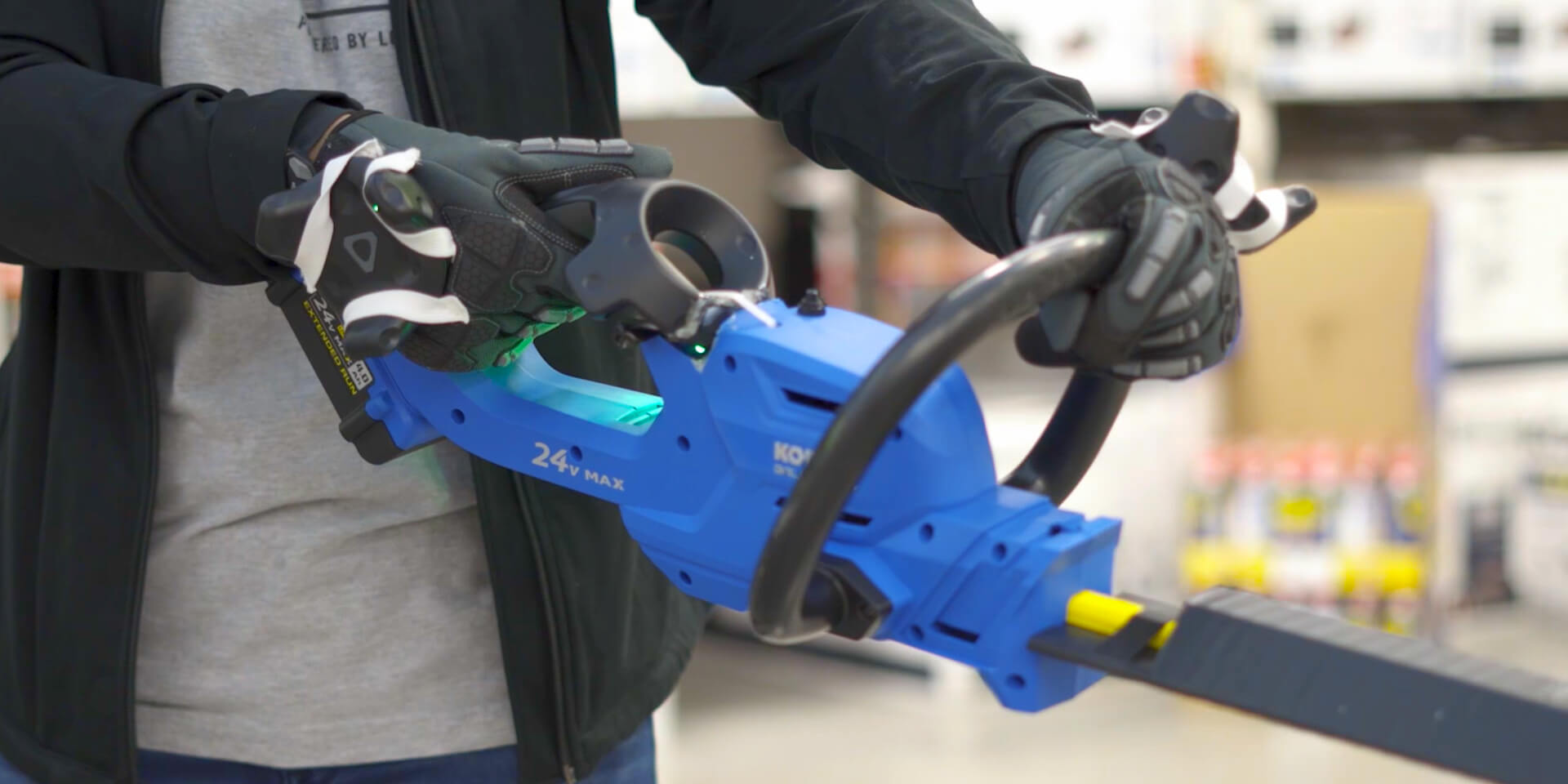 customer holding a virtual power tool to experience in a VR environment