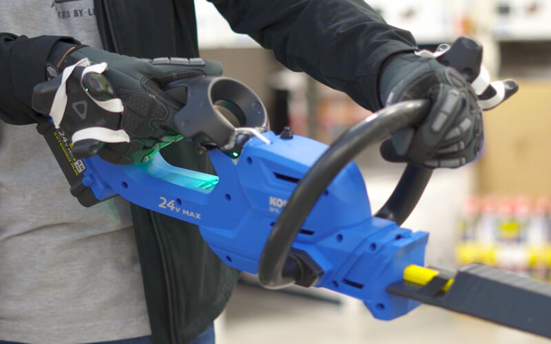 customer holding a virtual power tool to experience in a VR environment